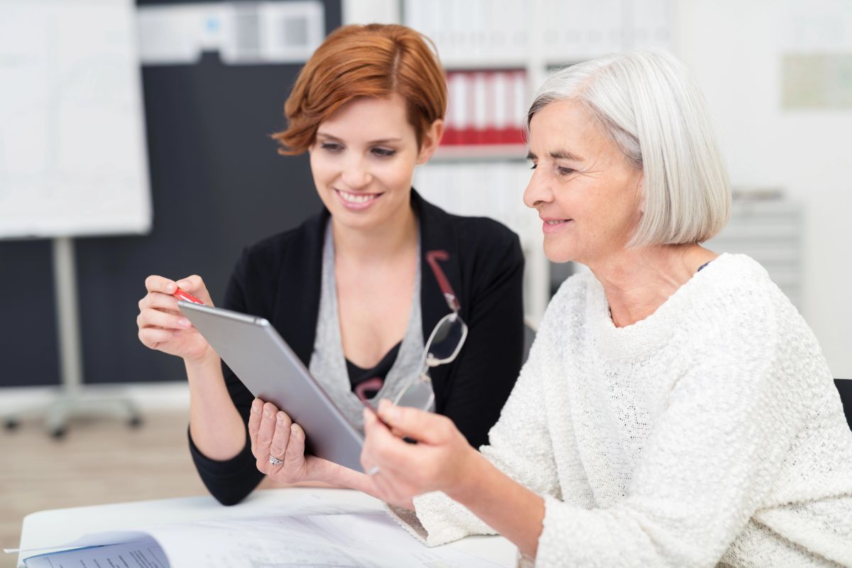 A younger and older worker at an office.